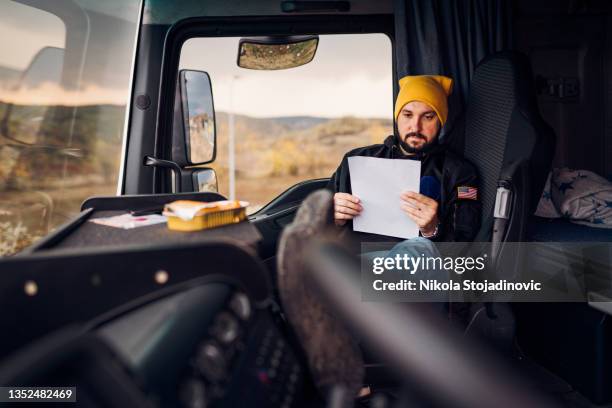 the truck driver checks the papers - loading dock ramps stock pictures, royalty-free photos & images