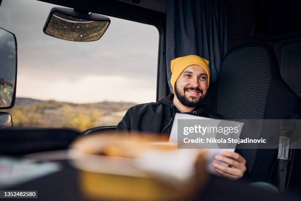 the truck driver checks the papers - travel writer stock pictures, royalty-free photos & images