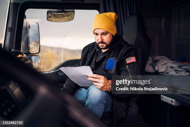 the truck driver checks the papers - loading dock ramps stock pictures, royalty-free photos & images