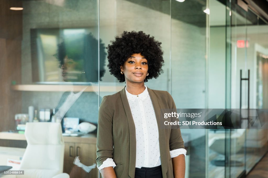 Confident female lawyer stands outside office