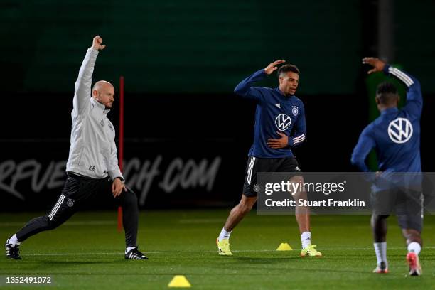 Lukas Nmecha of Germany stretches during a training session on day ahead of the 2022 FIFA World Cup Qualifier between Germany and Liechtenstein at...