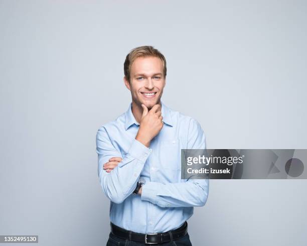 portrait of friendly young businessman - kin in de hand stockfoto's en -beelden