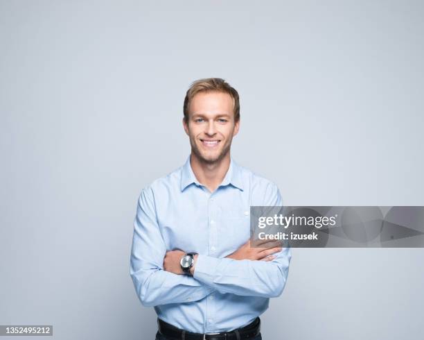 portrait of friendly young businessman - gray background stock pictures, royalty-free photos & images