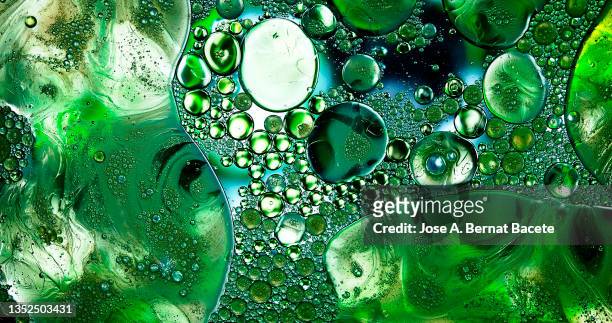 full frame of abstract shapes and textures formed of bubbles and drops on a liquid background. - amoeba imagens e fotografias de stock