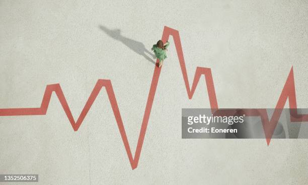 woman walking on painted pulse trace graph - heart attack stock pictures, royalty-free photos & images