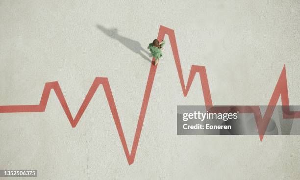 woman walking on painted pulse trace graph - ataque cardíaco imagens e fotografias de stock