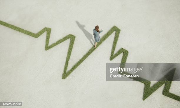 woman walking on grassy pulse trace graph - advance health care imagens e fotografias de stock