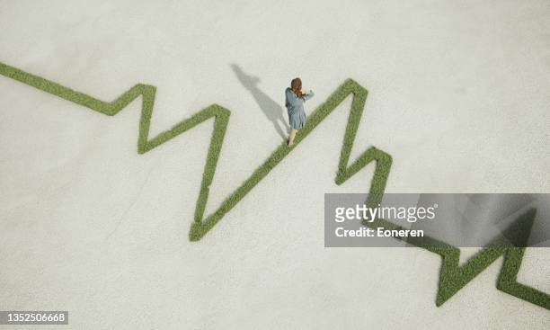 woman walking on grassy pulse trace graph - environmental issues 個照片及圖片檔