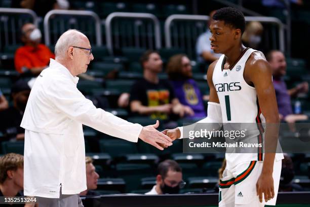 Anthony Walker of the Miami Hurricanes high fives head coach Jim Larranaga against the Canisius Golden Griffins during the second half at Watsco...