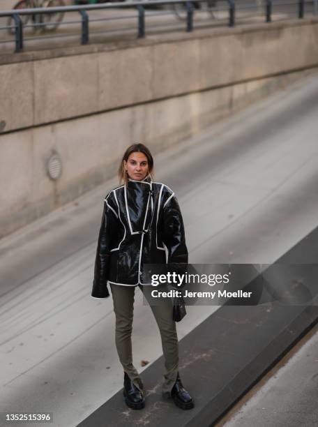 Anna Winter wearing a black Stine Goya jacket, a green Jacquemus pants and black Prada shoes on November 10, 2021 in Berlin, Germany.