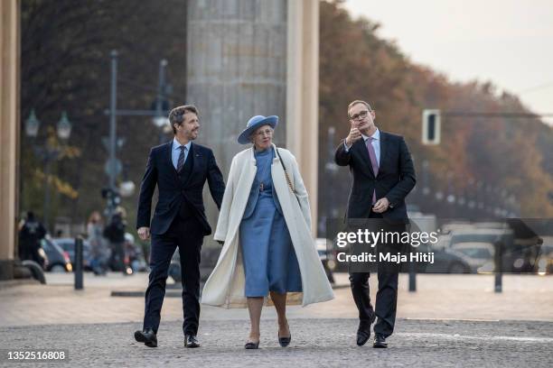 Crown Prince Frederik of Denmark, Queen Margrethe II of Denmark and Berlin Mayor Michael Mueller visit the Brandenburg Gate on November 10, 2021 in...