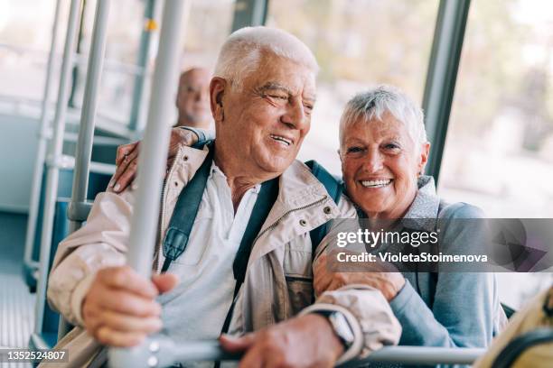 senior couple using public transportation. - public transportation stock pictures, royalty-free photos & images
