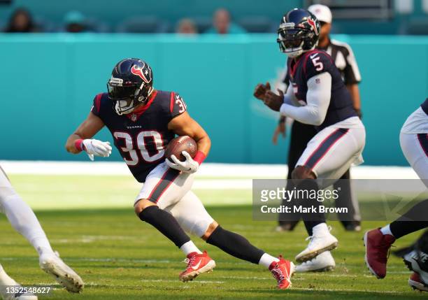 Phillip Lindsay of the Houston Texans runs with the ball against the Miami Dolphins at Hard Rock Stadium on November 07, 2021 in Miami Gardens,...
