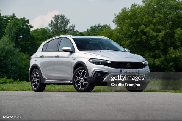 fiat tipo cross on a road - fiat stock pictures, royalty-free photos & images