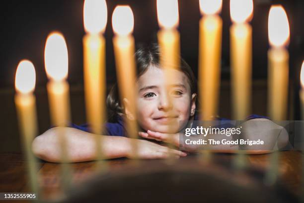 little girl looking at menorah during hanukkah - celebrating the life of clark hulings an american master stockfoto's en -beelden