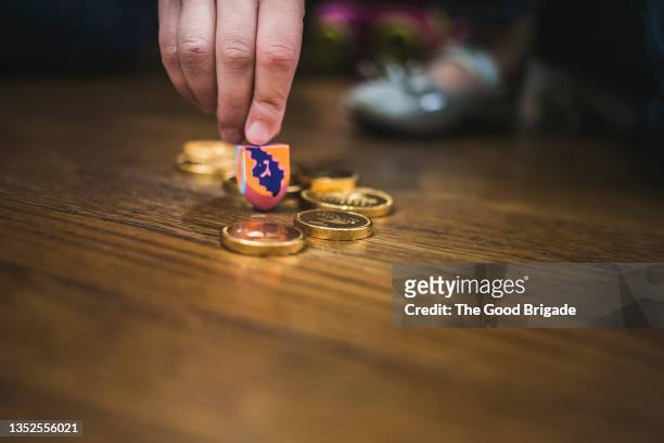 close up of hand spinning dreidl - geld stock pictures, royalty-free photos & images