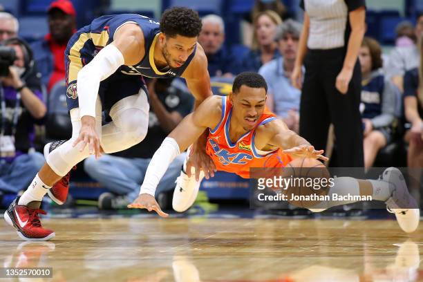Josh Hart of the New Orleans Pelicans and Darius Bazley of the Oklahoma City Thunder go for a loose ball during the first half at the Smoothie King...