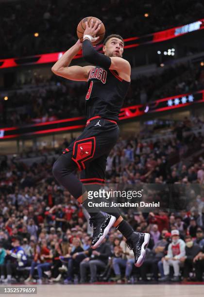 Zach LaVine of the Chicago Bulls does a 360 degree spin as goes up for a dunk against the Dallas Mavericks at the United Center on November 10, 2021...