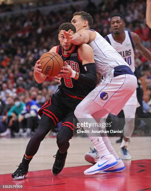 Zach LaVine of the Chicago Bulls is hit in the face by Dwight Powell of the Dallas Mavericks as he drives to the basket at the United Center on...
