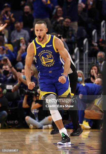 Stephen Curry of the Golden State Warriors reacts after he assisted on a dunk by Gary Payton II in the first half of their game against the Minnesota...