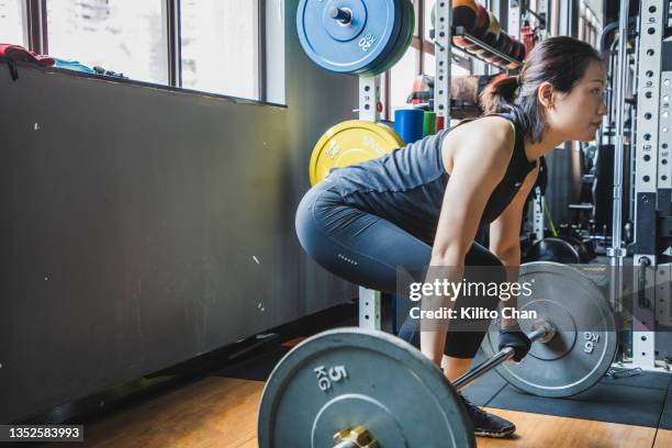 asian woman lifting weights in a gym - snatch weightlifting stock pictures, royalty-free photos & images