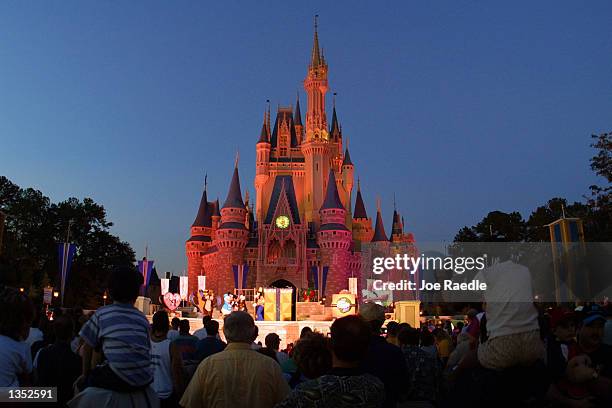 People watch a show on stage in front of Cinderella's castle at Walt Disney World's Magic Kingdom November 11, 2001 in Orlando, Florida. Health...