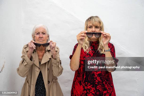 informal portrait two women mimicing each other - schoondochter stockfoto's en -beelden