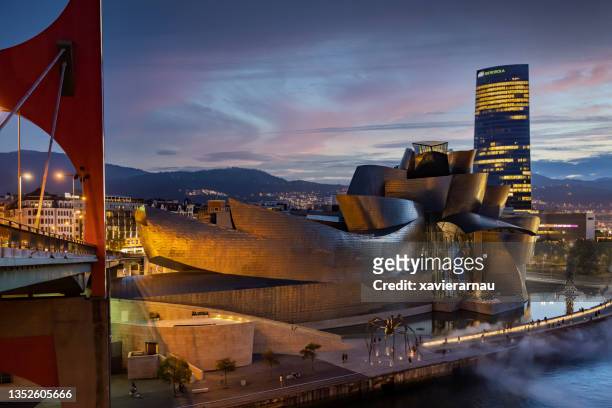 guggenheim museum bilbao at dusk - frank gehry stock pictures, royalty-free photos & images