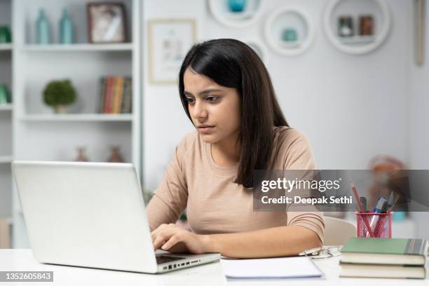 young woman working at home, stock photo - indian ethnicity laptop stock pictures, royalty-free photos & images