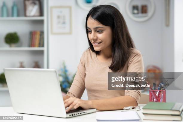 young woman working at home, stock photo - beautiful college girls stock pictures, royalty-free photos & images