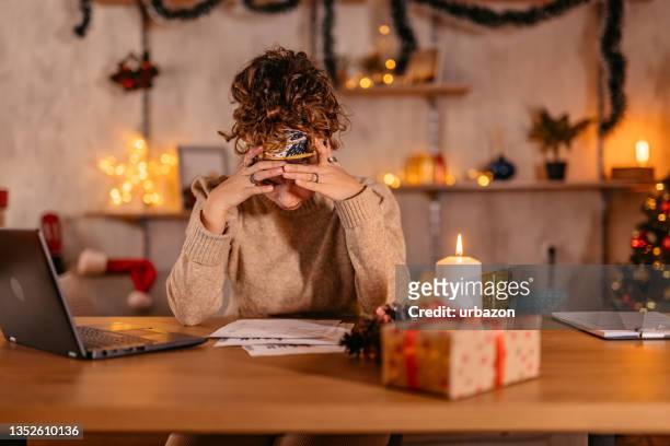 worried woman manage household finance at christmas - christmas stress stock pictures, royalty-free photos & images