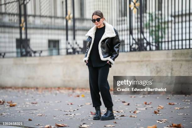 Diane Batoukina @diaanebt wears black sunglasses from Chanel, a black round-neck knit pullover from Zara, a black shiny leather with white sheep...