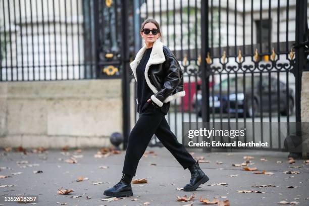 Diane Batoukina @diaanebt wears black sunglasses from Chanel, a black round-neck knit pullover from Zara, a black shiny leather with white sheep...