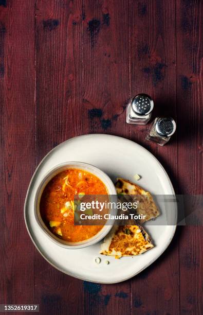 bowl of soup with sandwich on a plate on red wooden background - soup and sandwich stock pictures, royalty-free photos & images