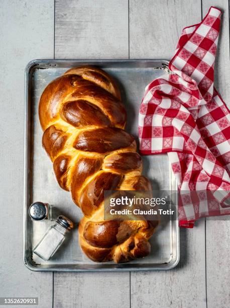 homemade braided bread on a tray on white, wooden background - braided bread stock pictures, royalty-free photos & images