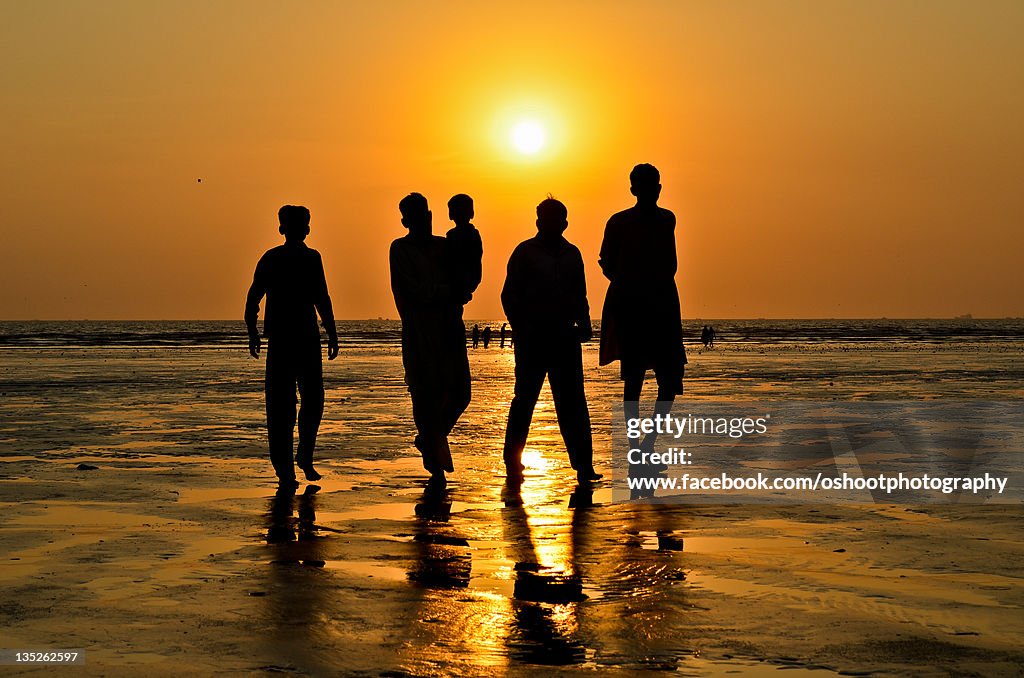 Silhouette of peoples on beach during sunset