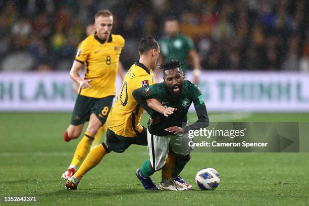 Feras Albrikan of Saudi Arabia is tackled by Trent Sainsbury of the Socceroos during the FIFA World Cup AFC Asian Qualifier match between the...