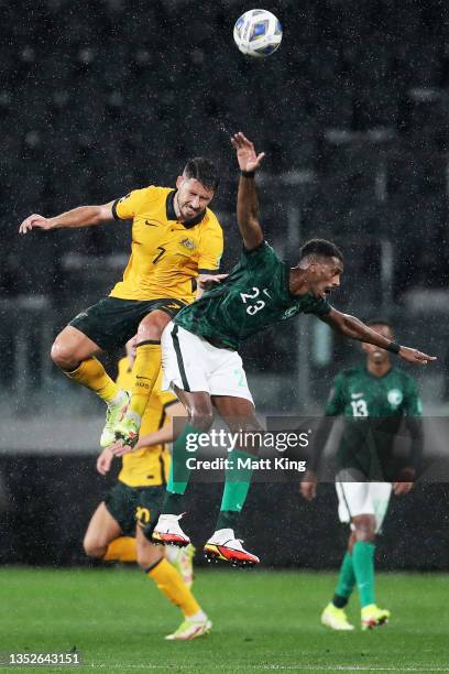 Matthew Leckie of Australia is challenged by Mohammed Kanno of Saudi Arabia during the FIFA World Cup AFC Asian Qualifier match between the Australia...