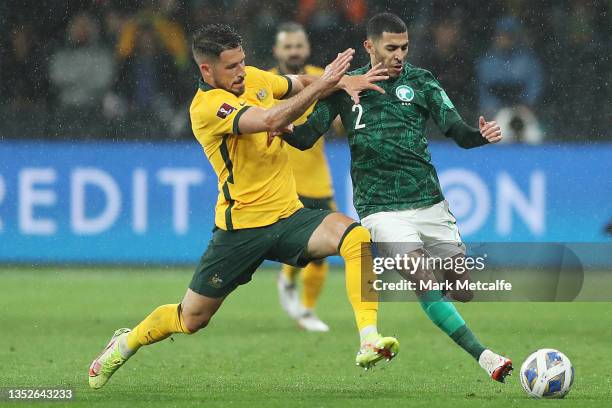 Matthew Leckie of Australia and Sultan Abdullah Alghannam of Saudi Arabia compete for the ball during the FIFA World Cup AFC Asian Qualifier match...