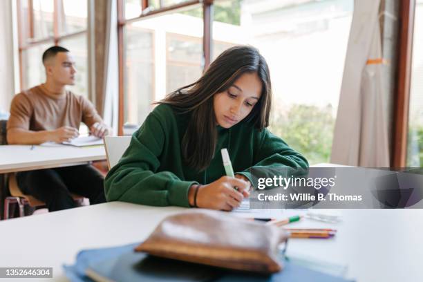 high school student concentrating during test - teen girl 15 sitting fotografías e imágenes de stock