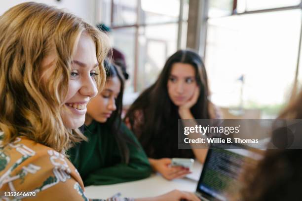 high school student studying at computer together with classmates - sólo chicas adolescentes fotografías e imágenes de stock