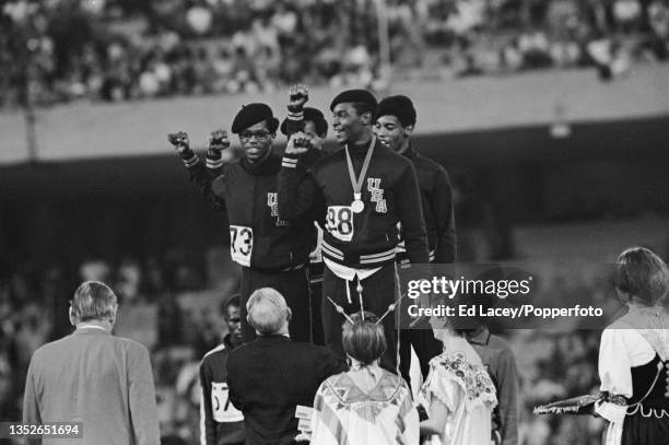 American athletes, in front from left, Ron Freeman and Vince Matthews and behind, Lee Evans and Larry James of the United States on the podium after...