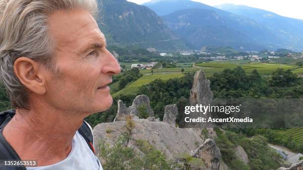 mature man explores hoodoos above lush valley - sierre bildbanksfoton och bilder