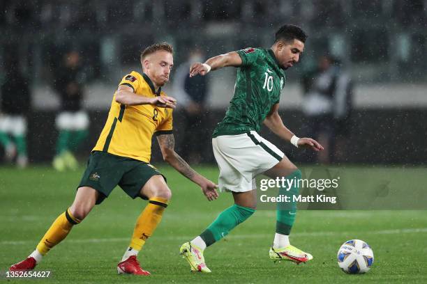 Salem Aldawsari of Saudi Arabia is challenged by James Jeggo of Australia during the FIFA World Cup AFC Asian Qualifier match between the Australia...