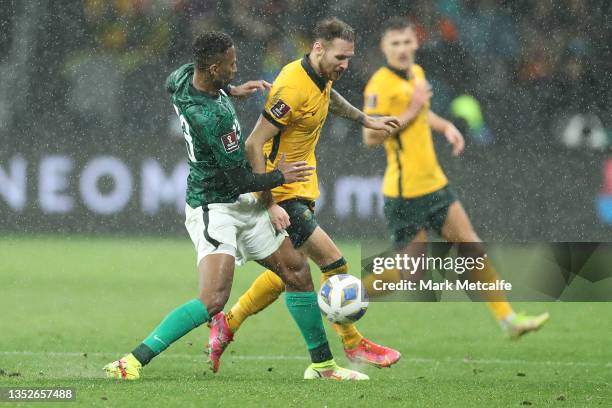 Martin Boyle of Australia and Nasser Essa Aldawsari of Saudi Arabia compete for the ball during the FIFA World Cup AFC Asian Qualifier match between...