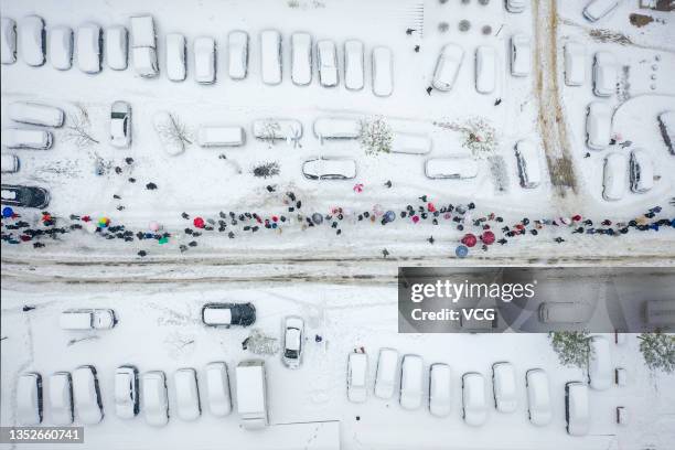 Aerial view of local residents queuing up for COVID-19 nucleic acid testing at a temporary COVID-19 testing site after a snowfall on November 8, 2021...