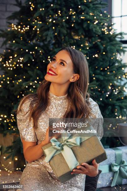 what is inside? - ethnic woman at christmas stock pictures, royalty-free photos & images