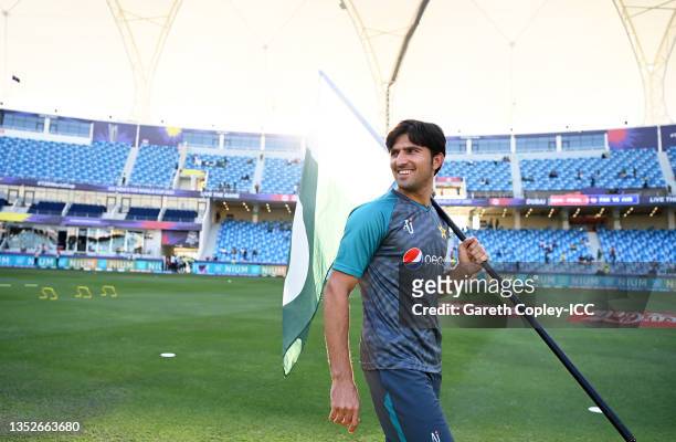 Mohammad Wasim of Pakistan carries out the flag ahead of the warm ups ahead of the ICC Men's T20 World Cup semi-final match between Pakistan and...