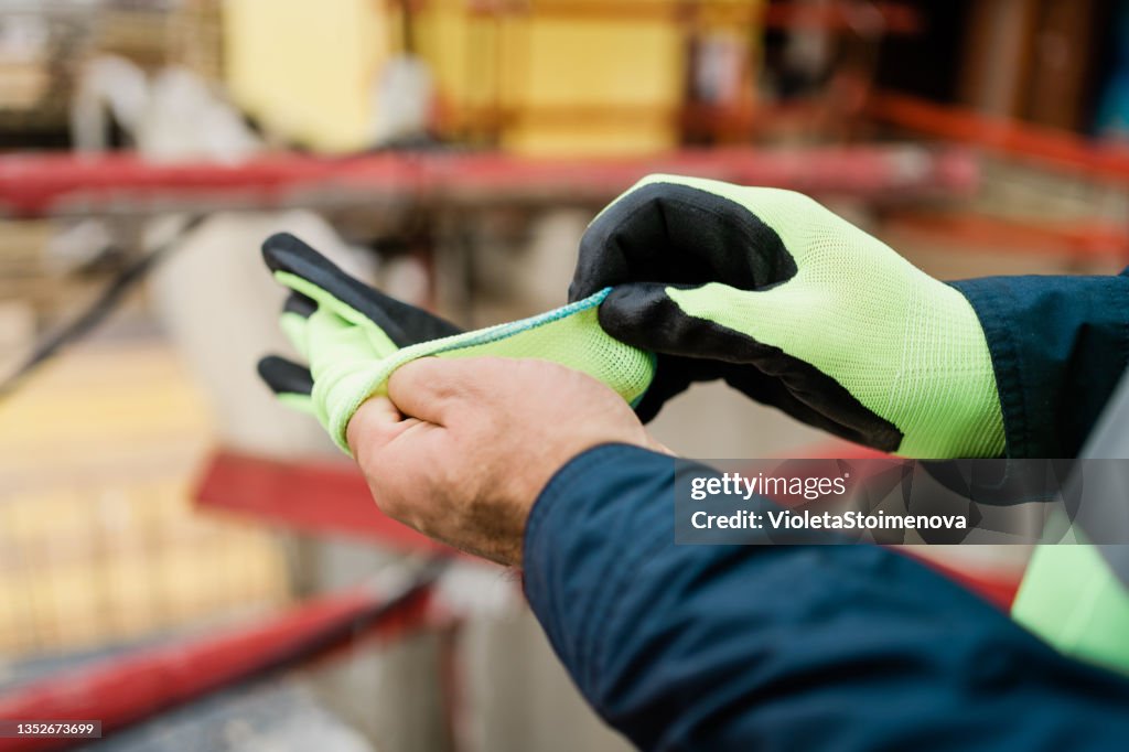 Handwerker auf der Baustelle mit Handschuhen.