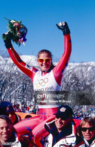 Picabo Street of USA on the shoulders of her coaches and celebrating after winning the gold medal in the Women's Super G at the Winter Olympics on...